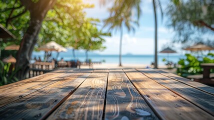 Obraz premium Empty wooden table, blurry backdrop of beach restaurant, hint of ocean view and sandy beach, tranquil and cozy ambiance
