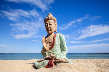 A buddha statue on a beach