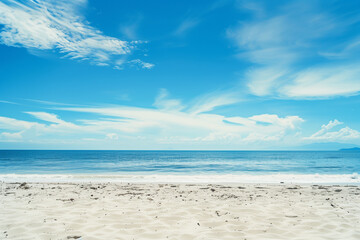 Fototapeta premium Sunlit Beach with Blue Sky and Ocean View