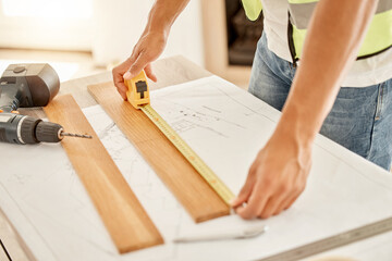 Handyman, hands and plank on table with tape for measurement, accuracy and wood for inspection....