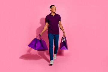 Full length photo of nice young male shopping bags walk look empty space dressed stylish violet...
