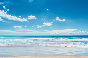 Obraz premium Sunlit Beach with Blue Sky and Ocean View
