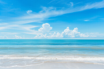 Obraz premium Sunlit Beach with Blue Sky and Ocean View