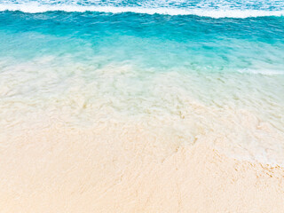 Ocean Tropical Beach with the soft wave water of the sea on the sandy beach background