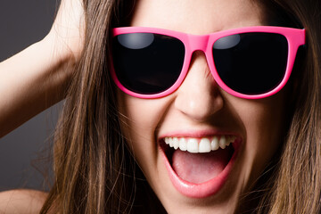 Happy, sunglasses and portrait of woman in studio for fun, excited and crazy with confidence....