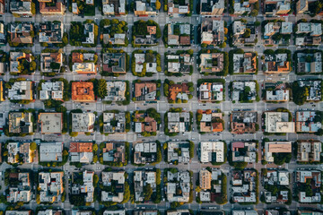 Top-down aerial view of a city grid, focusing on the symmetry and repetitive patterns of streets and buildings. 
