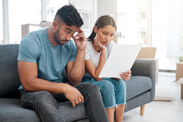 Frustrated couple, sofa and documents with debt for financial crisis, expenses or bills at home. Man and woman in concern, stress or anxiety with paperwork for mortgage, house loan or eviction notice