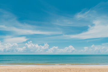 Obraz premium Sunlit Beach with Blue Sky and Ocean View