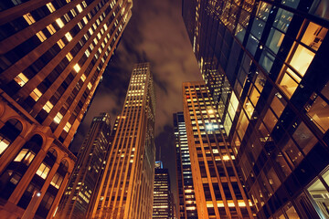 Urban Majesty: Nighttime Perspective of Skyscrapers from Below