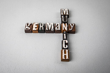 GERMANY MUNICH. Alphabet blocks, crossword puzzle on gray textured background