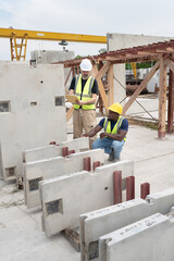 Portrait happy African American engineer man working with caucasian engineer man at precast cement...