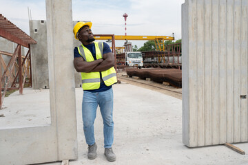 Cross arm Portrait African engineer man with precast cement at precast cement outdoor factory	
