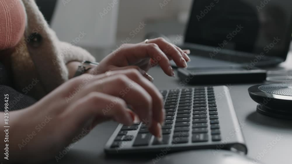 Wall mural closeup of unrecognizable female hands of programmer typing on wireless keyboard at office desk