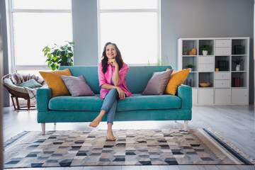 Photo of dreamy adorable senior woman wear trendy clothes sitting alone living room comfortable...