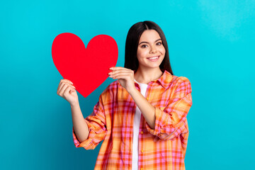 Photo of nice young girl hold heart symbol wear plaid shirt isolated on teal color background