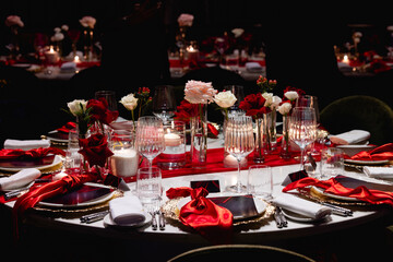 A red napkin on a luxurious wedding table for guests creates an elegant ambiance through beautiful table setting. A table setting in red.Christmas and New Year - Powered by Adobe