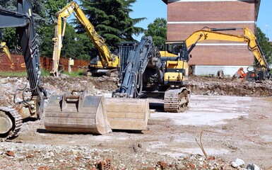 Group of heavy excavators  flattening the ground at the construction site	