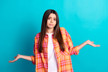Photo of nice young girl shrug shoulders wear plaid shirt isolated on teal color background