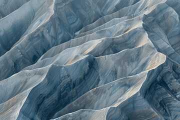 Obraz premium Minimalist aerial view of mountain ridges, showcasing sharp lines and natural patterns in the terrain. 