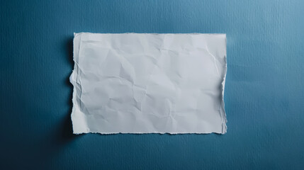 Obraz premium A minimalist crumpled white paper on a serene blue background.