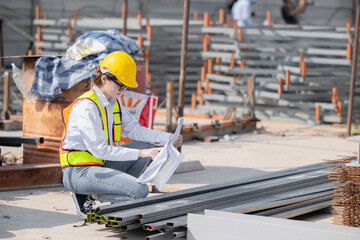 Female Construction Worker Inspecting Materials On Construction Site