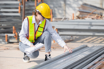 Female Construction Worker Inspecting Materials On Construction Site