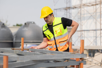Construction Worker Inspecting Structure and Experiencing Low Back Pain