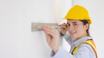 Beauty women construction worker model with Cement wall Plastering Tool looking camera happy smiling