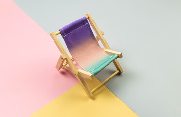 Colorful beach chair on colorful background. Summer, holidays and beach concept. Creative...