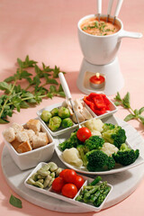 Cheese fondue with vegetables and oregano.