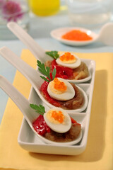 Escalivada spoons with quail eggs.