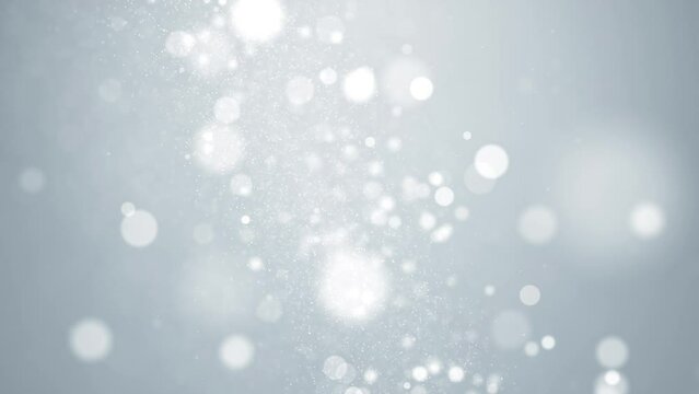 Shiny bokeh lights and glittering particles on luxurious blurred background.