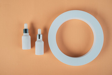 Plastic white tube for cream or lotion. Skin care or sunscreen cosmetic with stylish props on cream background.