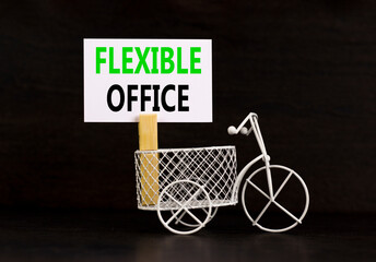 Flexible office symbol. Concept words Flexible office on beautiful white paper on wooden...