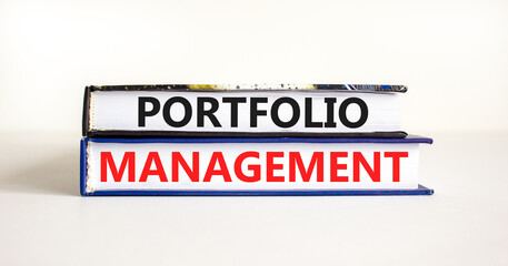 Obraz premium Portfolio management symbol. Concept words Portfolio management on beautiful books. Beautiful white paper background. Business Portfolio management concept. Copy space.