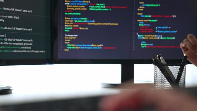 Slow motion closeup hand, back end software developer engineer for computer programming working together on debugging writing computing code, solving complex algorithms display on monitor. Burgeoning