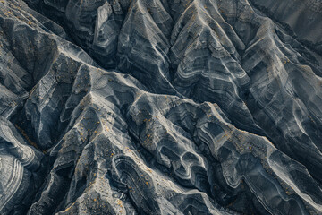 Minimalist aerial view of mountain ridges, showcasing sharp lines and natural patterns in the terrain. 