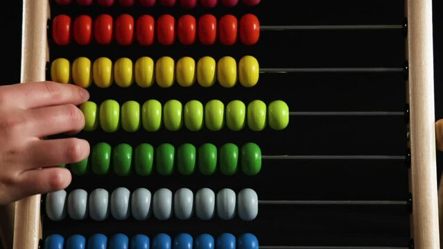 Child Using Colorful Abacus