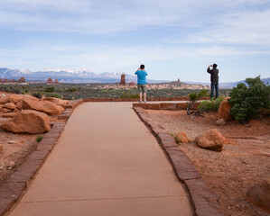 Tourists taking photos using smartphones at Arches National Park. Utah. USA.
