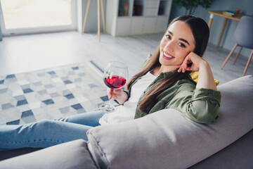 Portrait of nice young woman toothy smile hold wine wear green shirt weekend modern flat indoors