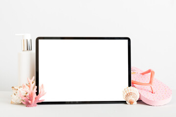 Flat lay composition with tablet and beach accessories on colored background. Tablet computer with...