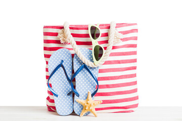 Stylish bag with beach accessories . Summer holiday concept. beach bag with straw hat with space...