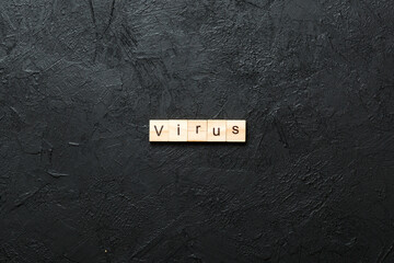 virus word written on wood block. virus text on cement table for your desing, concept