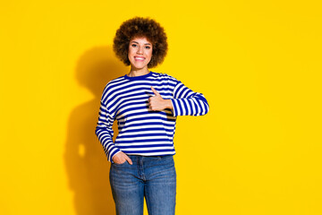 Photo of nice young girl show thumb up empty space wear striped shirt isolated on yellow color...
