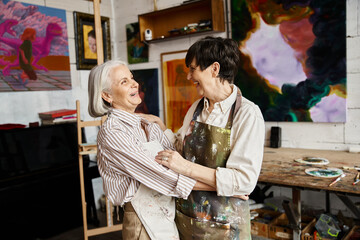 Two women creating art in a studio.