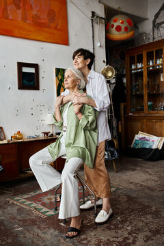 Woman affectionately hugs her parter in a cozy room.