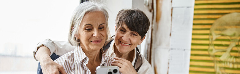Two women taking a self-portrait with smartphone.