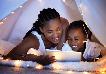 Tablet, relax and mother with kid in tent watching movie, video or show online in bedroom at home....