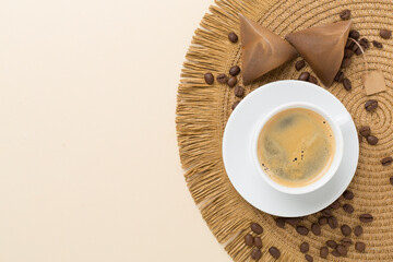 Cup of coffee made using pyramid on wooden background, top view