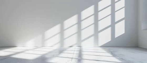 Obraz premium Abstract play of light and shadow on a white wall, from a window grating.